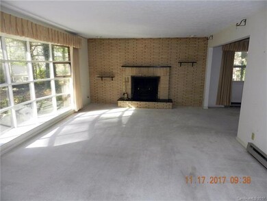 Spacious living room with bay window and fireplace