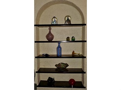 Living Room. Built in arched shelving...