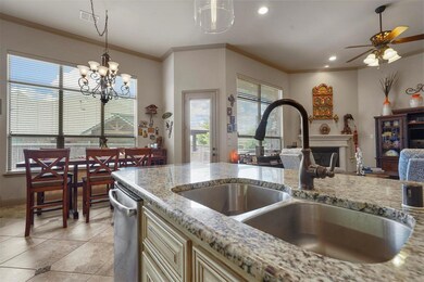 Kitchen with decorative light fixtures, light tile