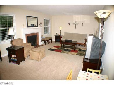 Living Room. This open yet comfortable living room is the perfect place for guests to gather around the traditional fireplace.