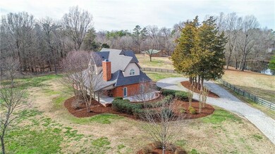 As you are enter through the double gated entry, you are greeted with professional landscaping and night lighting. The front entrance also has a gravel circle driveway.