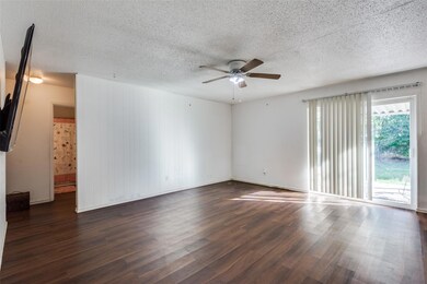 Spacious living room with ceiling fan
