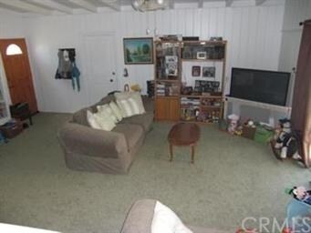 View of den from living room.  Door to garage is s