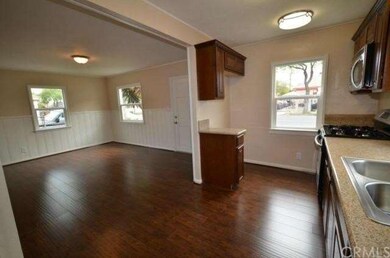 Kitchen and living area with new hardwood floors a