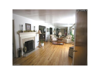 Living Room with pretty gas fireplace, gleaming ha