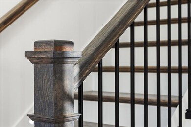 Architectural staircase with custom iron balusters