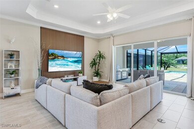 Living area with a sunroom, a ceiling fan, a raise