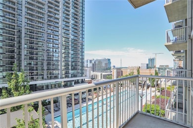 Balcony with view of pool area and a city view