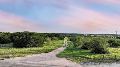 View of road with a rural view and a gated entry