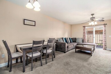 Living room with a chandelier, carpet, baseboards,