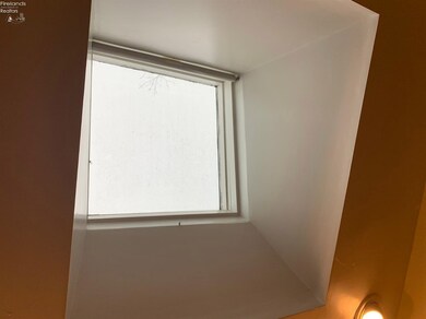 Skylight offers natural light to the kitchen space.