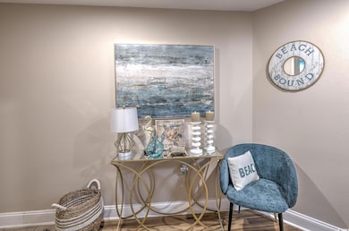 Living area with baseboards and wood finished floors