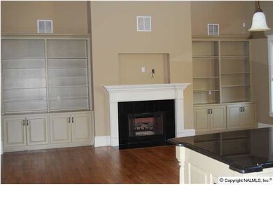Family room 2 story, Built in's on the one wall. Coffered ceiling, sand and finished floors. Wired for speakers, surround sound, whole house audio, intercom system. sand and finished floors. Leads out to large covered porch and patio with fireplace.