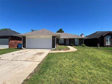 Ranch-style house featuring a garage, a front lawn