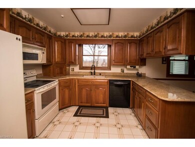 Beautifully updated cherry cabinets provide ample 