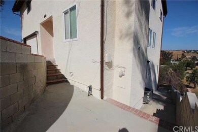 Supra on water pipe, enter stairway right of gate