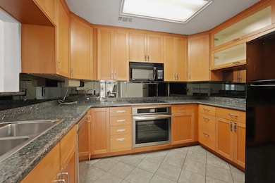 This kitchen has granite counters, plenty of stora