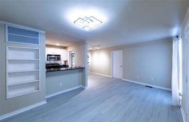 Kitchen with white cabinetry, dark countertops, vi