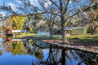 Serene view from canal of house and boathouse