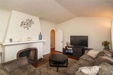 Living room with fireplace and hardwood floors.