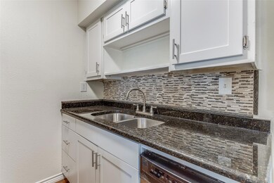 Kitchen with a sink, tasteful backsplash, white c