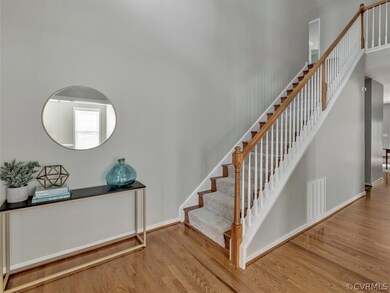 2 story grand foyer with wood floors.