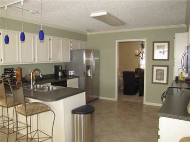 The spacious kitchen is accented with tile floor, 
