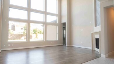 Soaring ceilings and wall-to-wall windows fill the