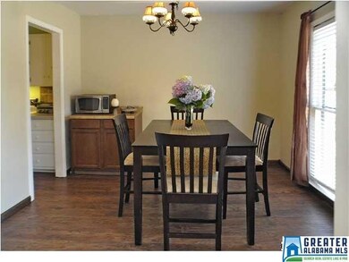 Spacious dining room with laminate hardwoods.