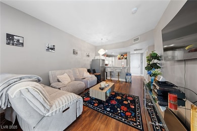 Living area featuring wood finished floors and vis