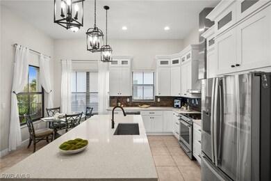 Kitchen featuring a notable chandelier, appliances