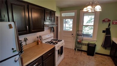 Gas stove, butcher block counters, dark cabinets, 