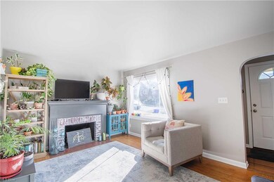 It features hardwood floors, a cozy living room wi