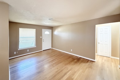 Entrance foyer with a textured ceiling and light wood-type flooring