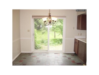 Doors from the Kitchen lead to the mature rear lan