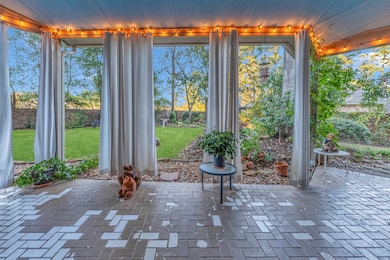 Large patio with white canvas curtains. Great for entertaining!