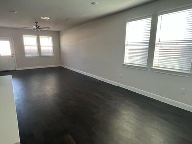 Spare room featuring a ceiling fan, baseboards, a