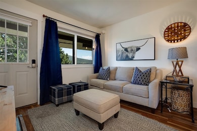 Living area with wood finished floors and healthy