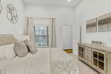 The bedroom has natural light with a window that l
