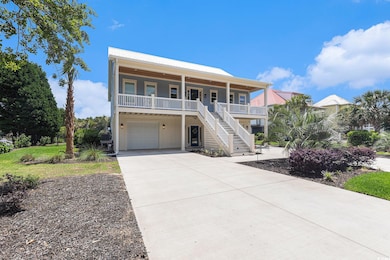 Raised beach house with a porch, a garage, stairs, driveway, and metal roof