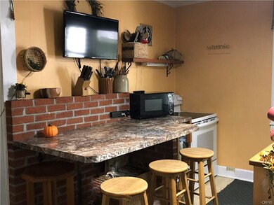 The kitchen features a breakfast bar, ...