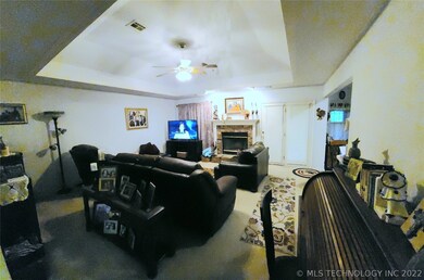 Large living area with gas log fireplace and vault