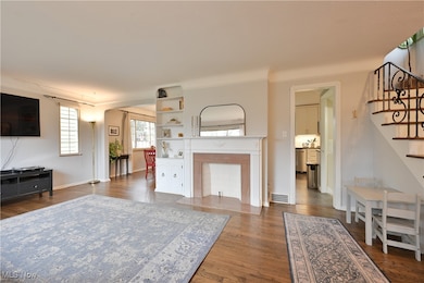 Living area featuring stairway and dark wood-style floors