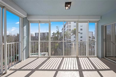 Unfurnished sunroom featuring a balcony