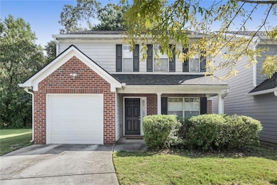 Traditional home featuring a shingled roof, brick 