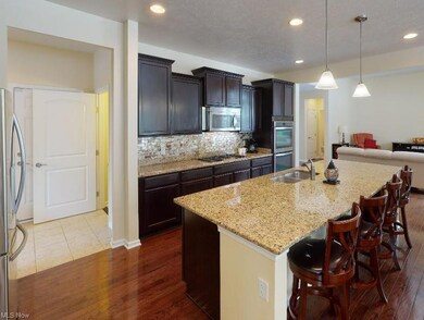 View of kitchen with granite countertops and large