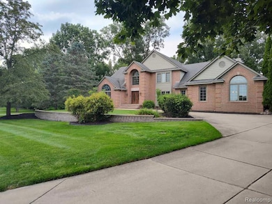 View of front of home featuring a front lawn and brick siding