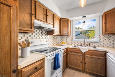 The kitchen features a generous amount of cabinets for storage.