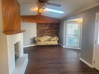 Unfurnished room featuring a fireplace, vaulted ce