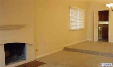 living room with cozy fireplace and berber carpet